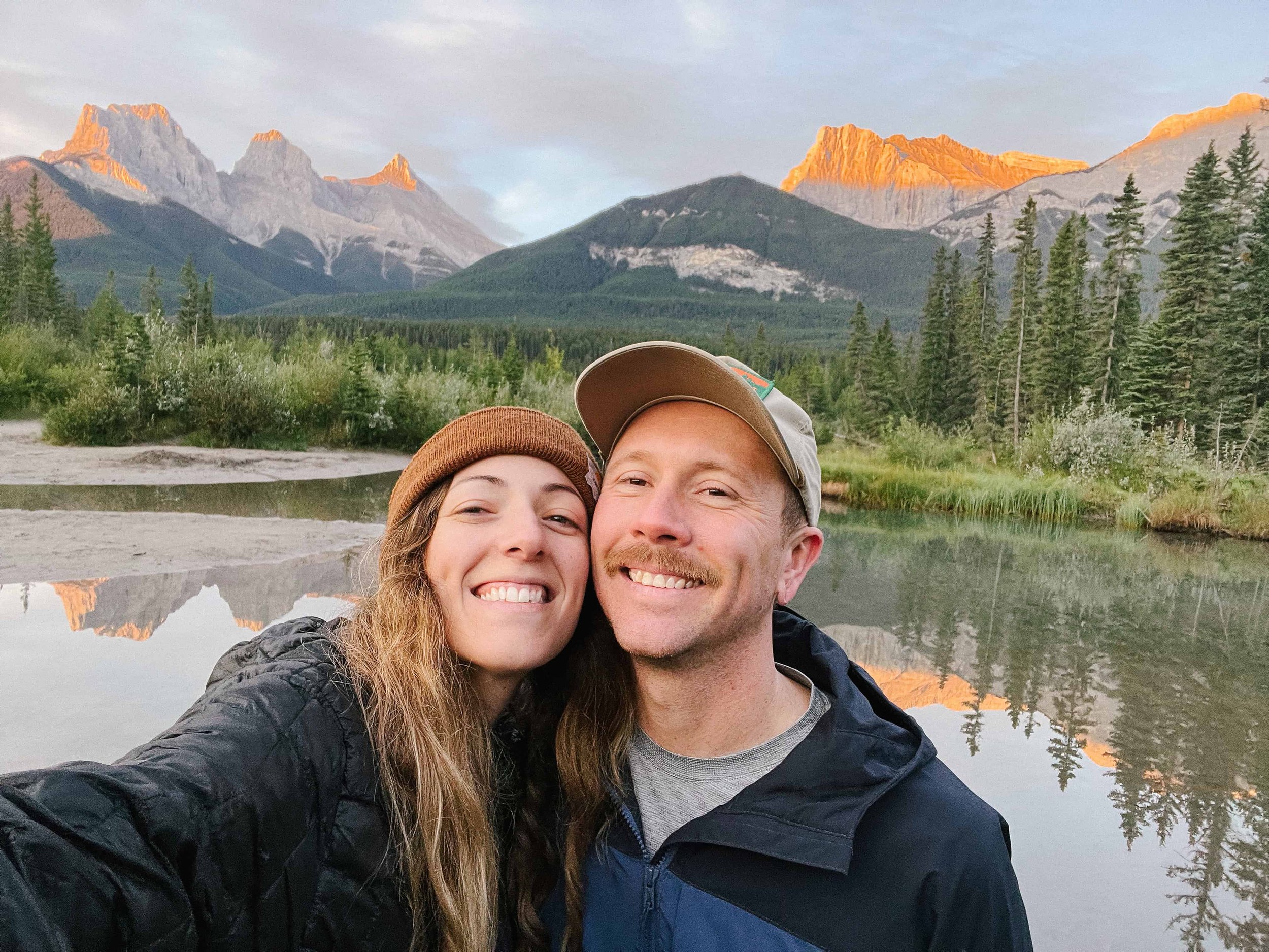 Kimberly Crist laughing with an eloping couple in the Colorado mountains