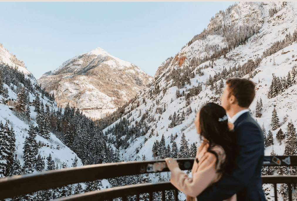 Winter elopement on a snowy overlook in Ouray, surrounded by snow covered mountains