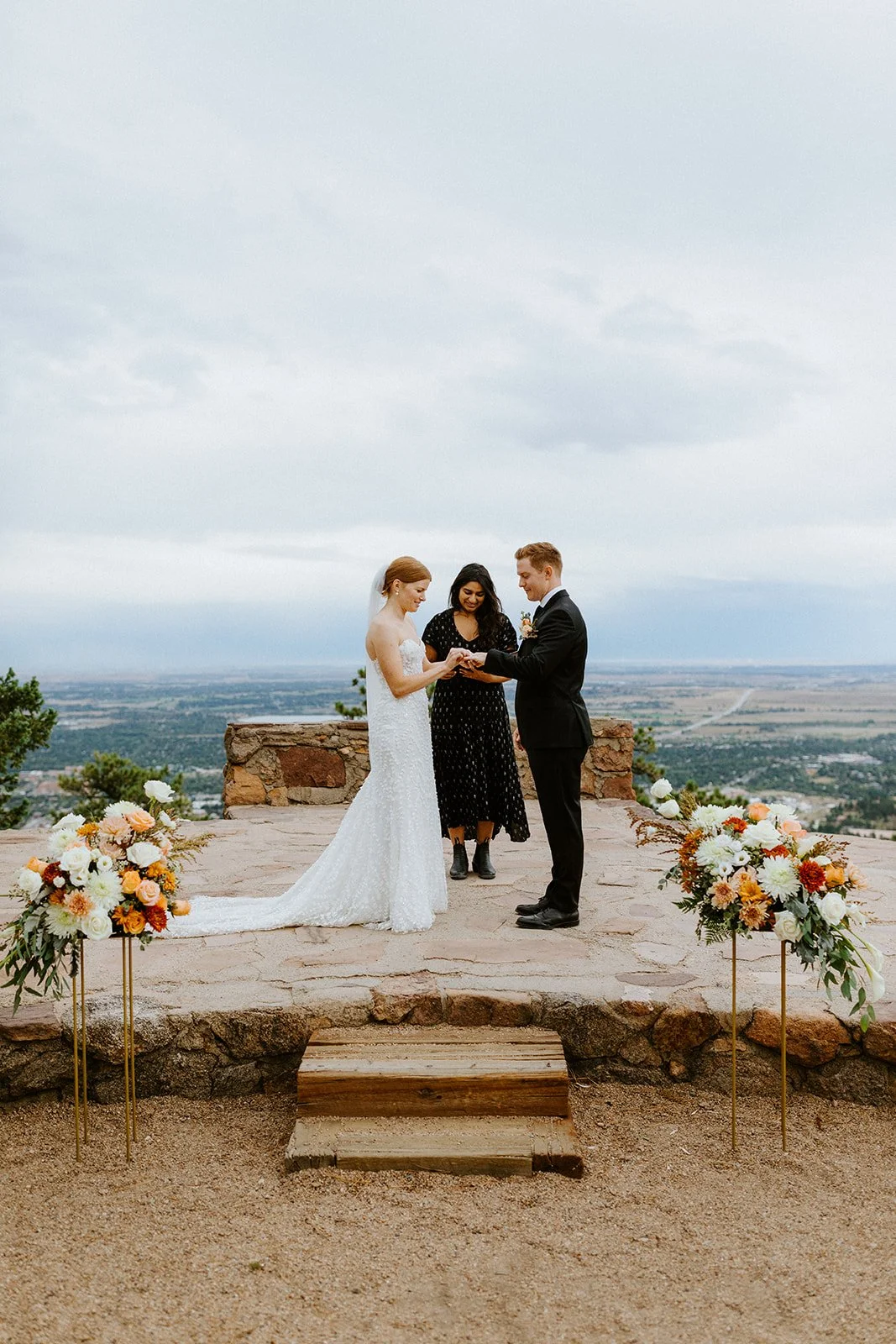 A bride and groom have a wedding ceremony at Sunrise Amphitheater in Boulder with flowers from Sturtz & Copeland