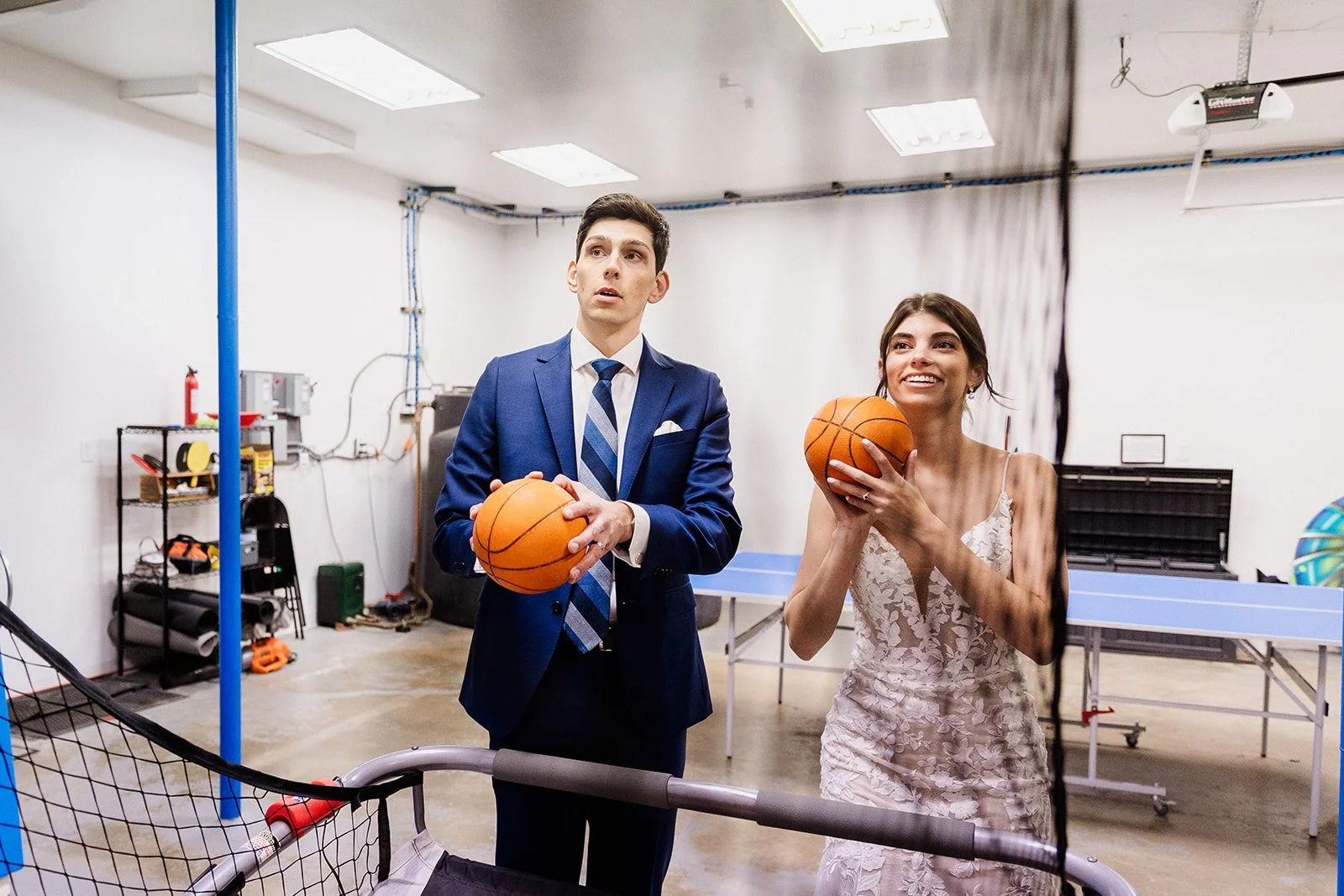 A bride and groom shoot basketballs at their post elopement party