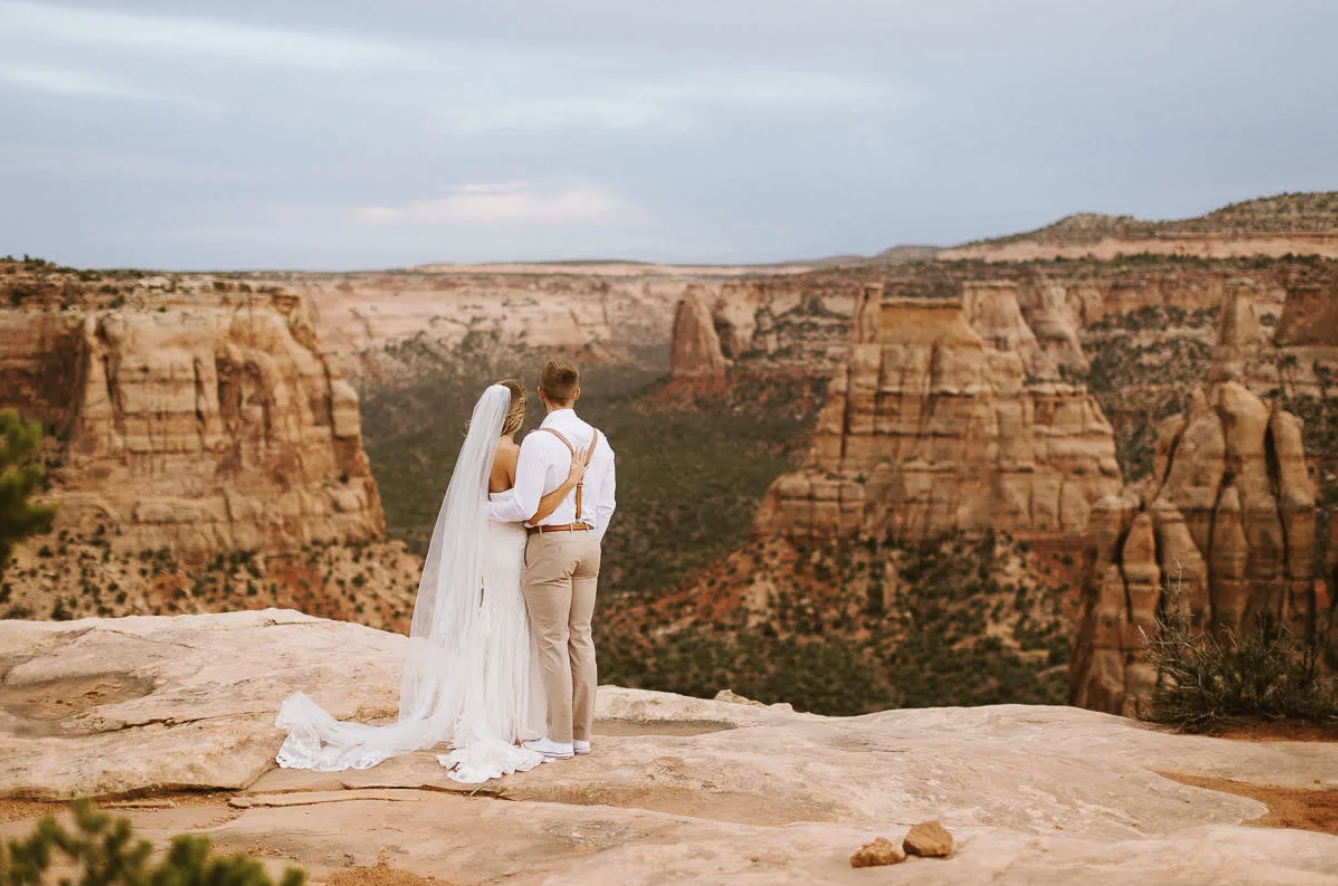 Couple eloping on red rock above the canyons of Colorado National Monument in Grand Junction