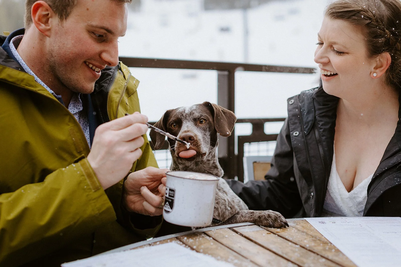 A couple shares whipped cream with their dog at the resort outside of Breckenridge on their elopement day