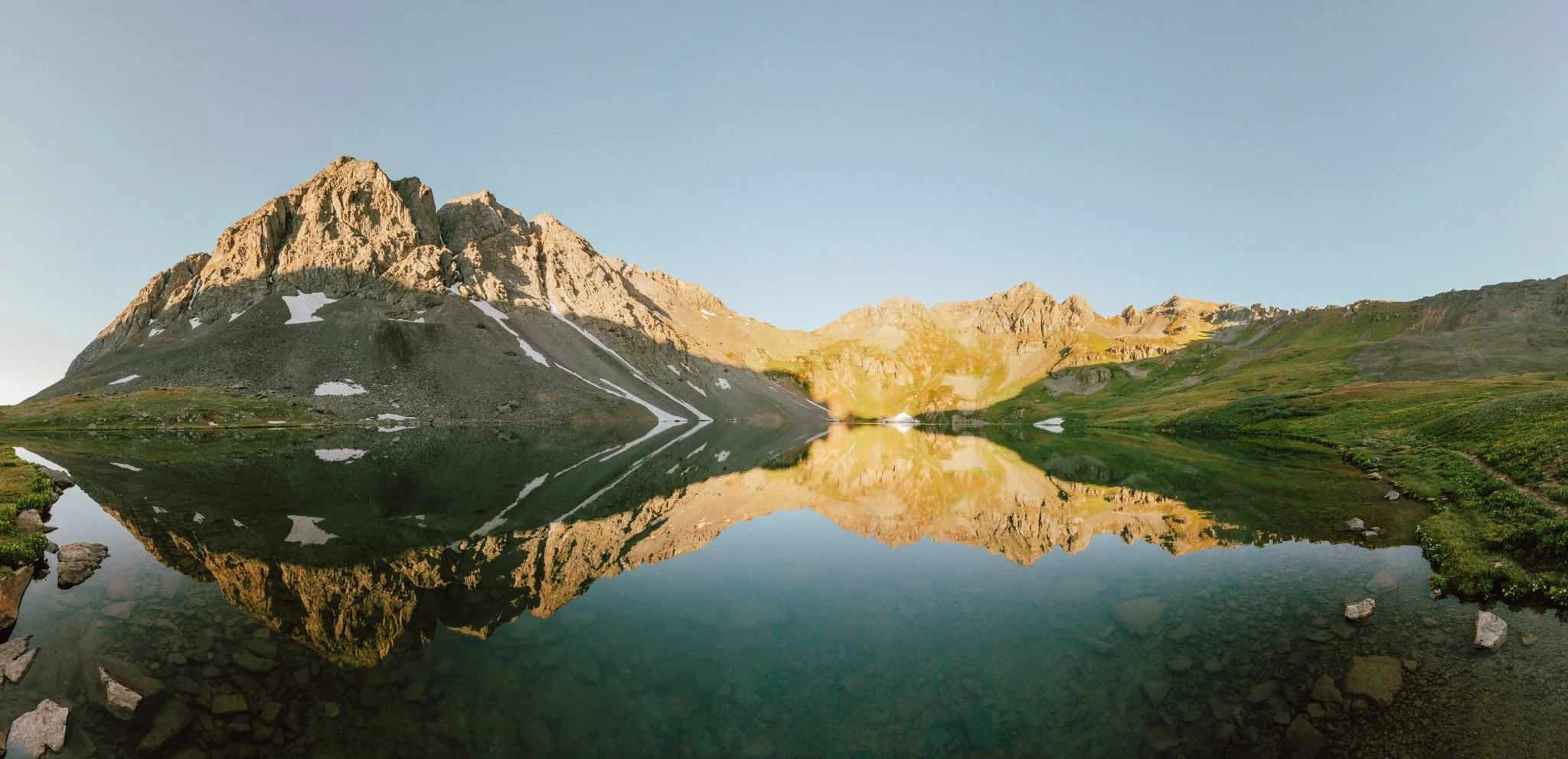 Cleak lake outside of Silverton, Colorado at sunrise with a still water reflection