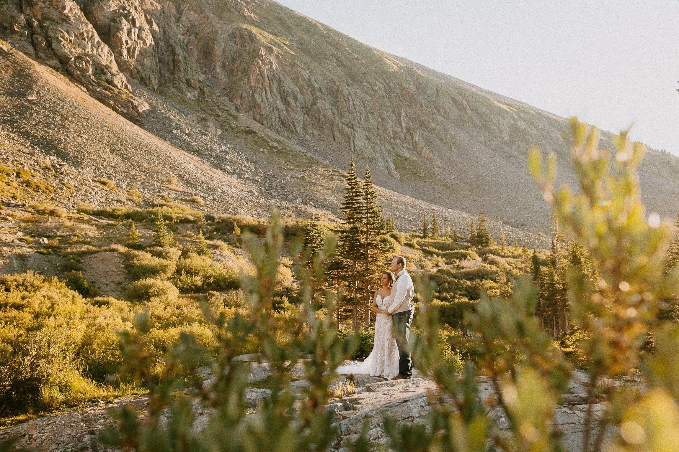 Couple eloping on rocky mountain terrain above Blue Lakes near Breckenridge during a Colorado fall elopement