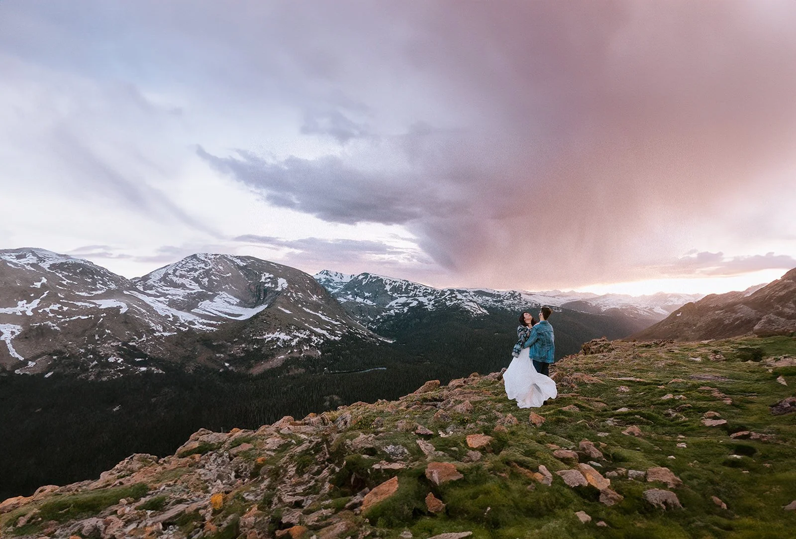 A couple stands at the top of Trail Ridge Road a driveable elopement location in Rocky Mountain National Park