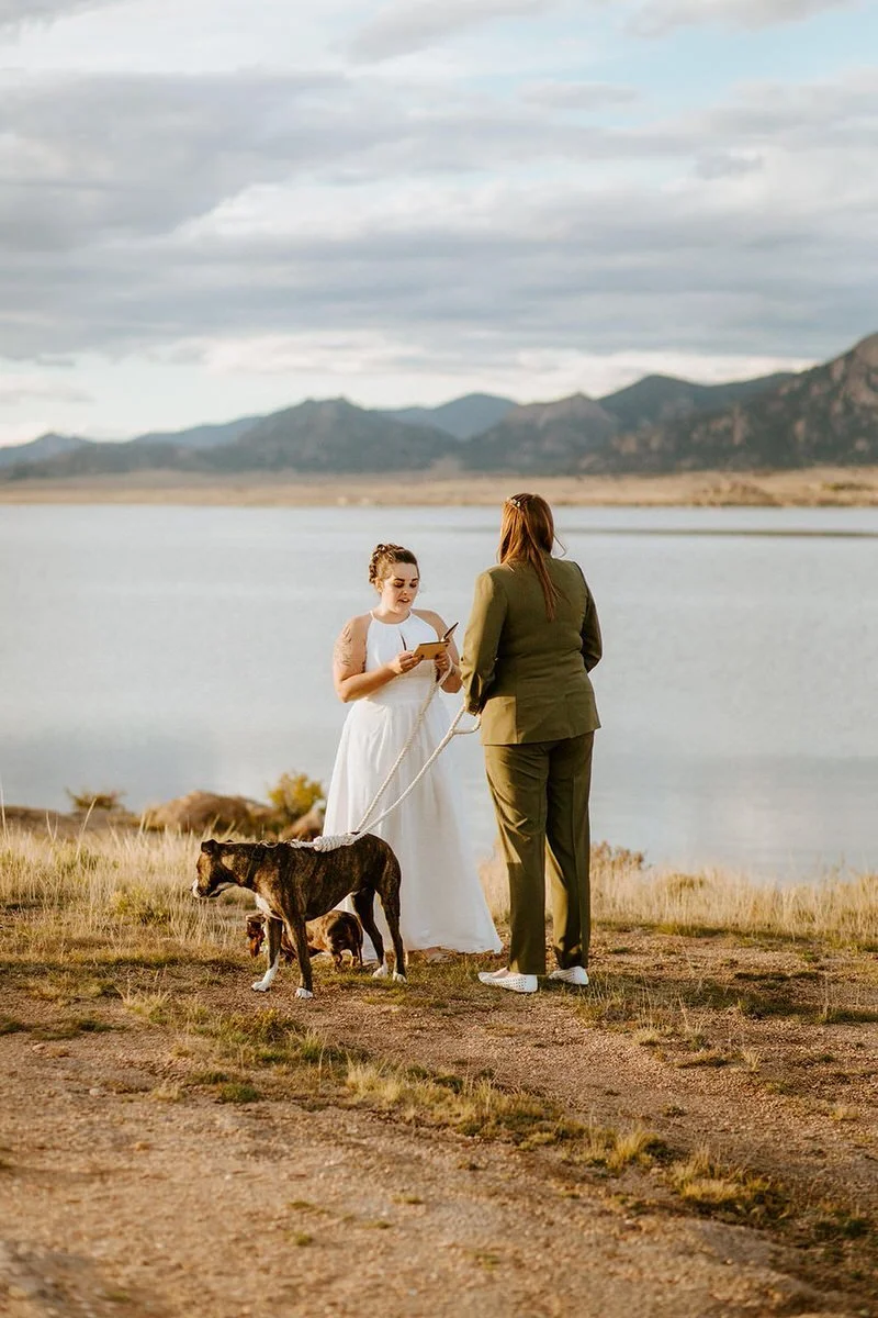 Bride exchanging vows near a mountain lake while holding their dog's leash at a Colorado elopement