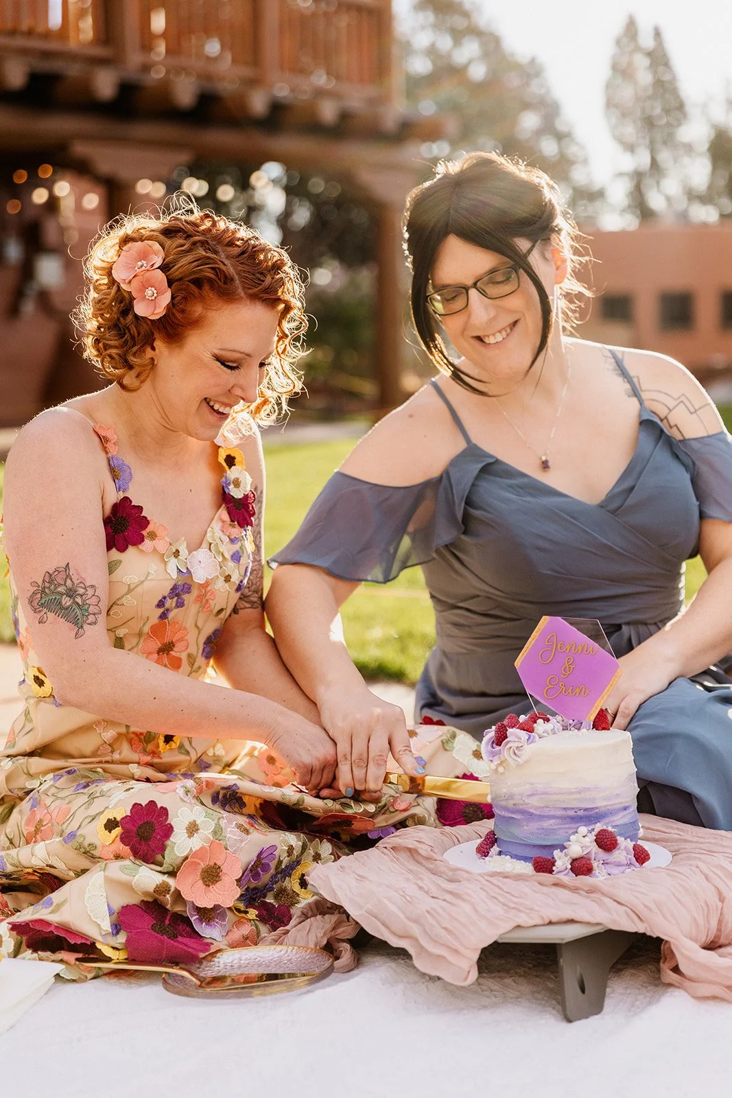 Two brides cutting a cake at Red Rocks Park and Amphitheater during their spring elopement