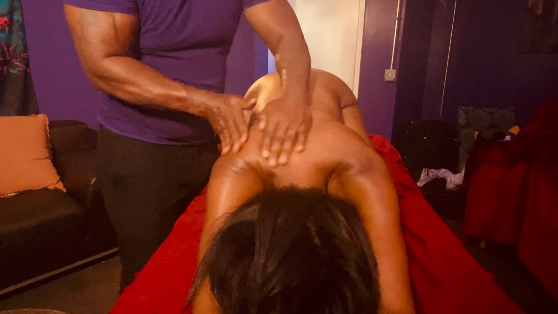 Client in child’s pose receiving therapeutic massage and spinal alignment targeting the back, hips, shoulders, and spine for deep tension release and postural correction.