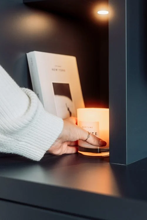 Katherine Elizabeth placing a candle in a finished corner of an interior design project in oxfordshire