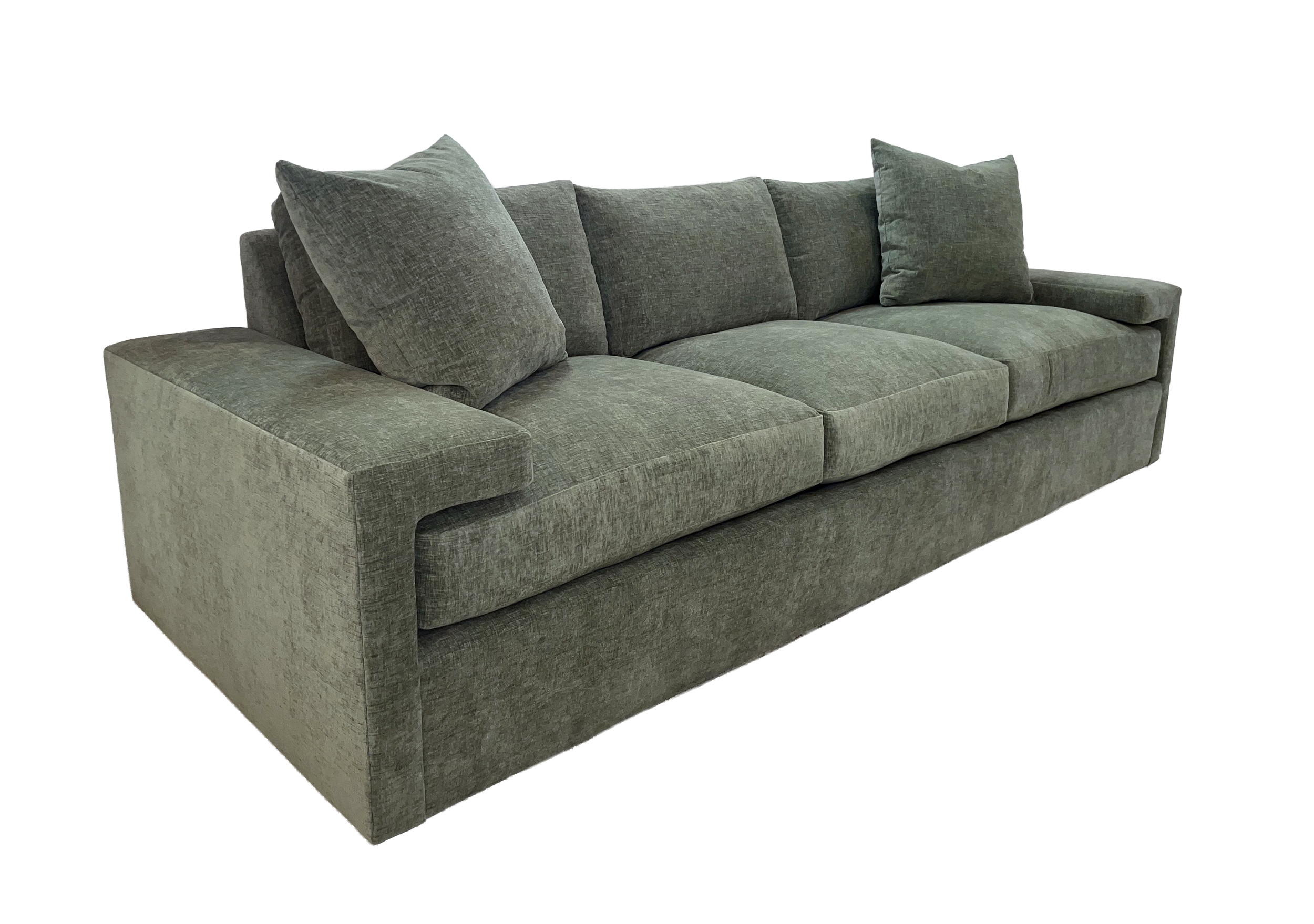 Two 20-inch goose feather-filled throw pillows, weltless with hidden zippers, upholstered in a green chenille fabric atop the Denby Sofa.