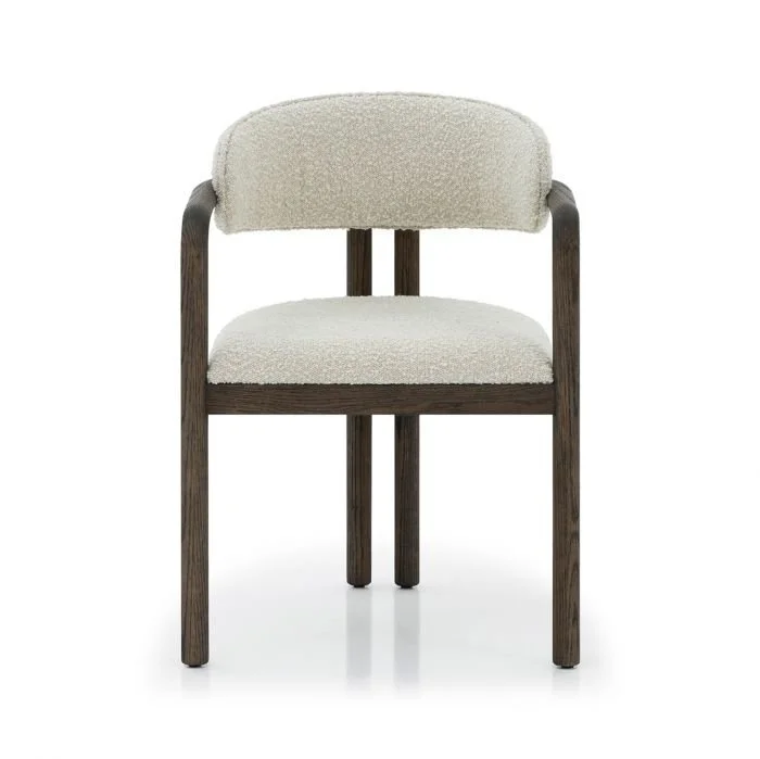 Take a seat in the Fowler Dining Chair, where an oak wood frame meets cozy boucle fabric.
