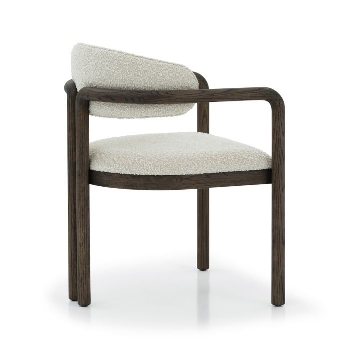 Sculptural wood frame that transitions into the arm of the Fowler Dining Chair.