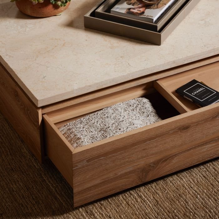 Blankets and trinkets stored inside the Branford Storage Cocktail Table drawers for easy living.