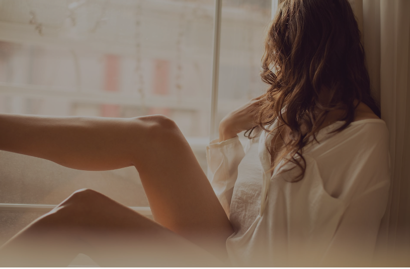 Woman sitting with bare legs that have very clear skin