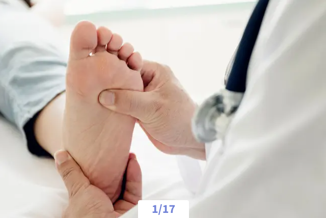 Doctor examining a patient's foot in a clinic setting.
