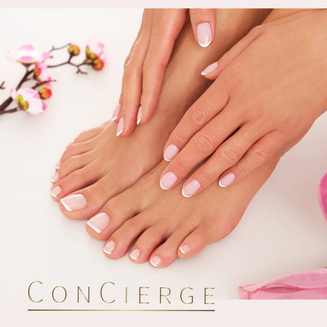 a woman holding her hands on her feet after getting a manicure and pedicure