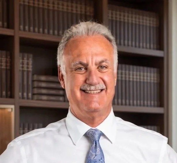 Ivar E. Roth, D.P.M, M.P.H. Board Certified Foot & Ankle Surgeon, American Board of Foot and Ankle Surgery, standing in his office.