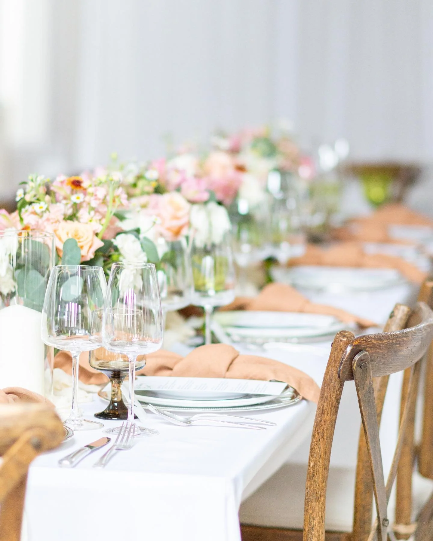 Elegant table setting with floral centerpiece and wine glasses