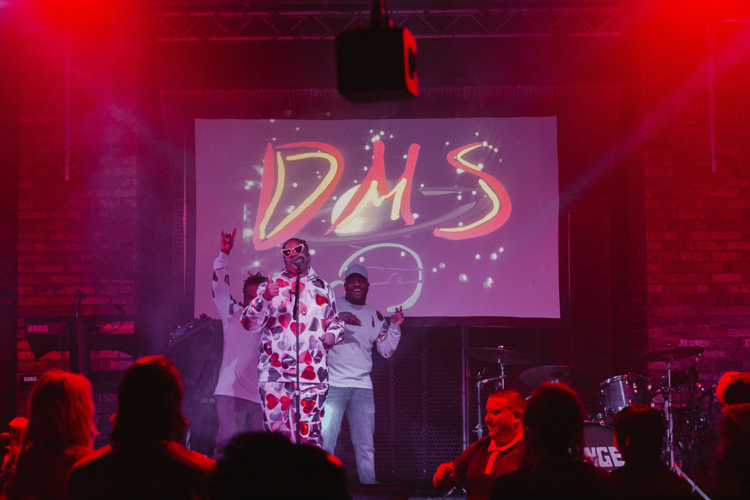 Photo of D.M.S with ipad drawn graphics behind her photo by Sian O'Connor