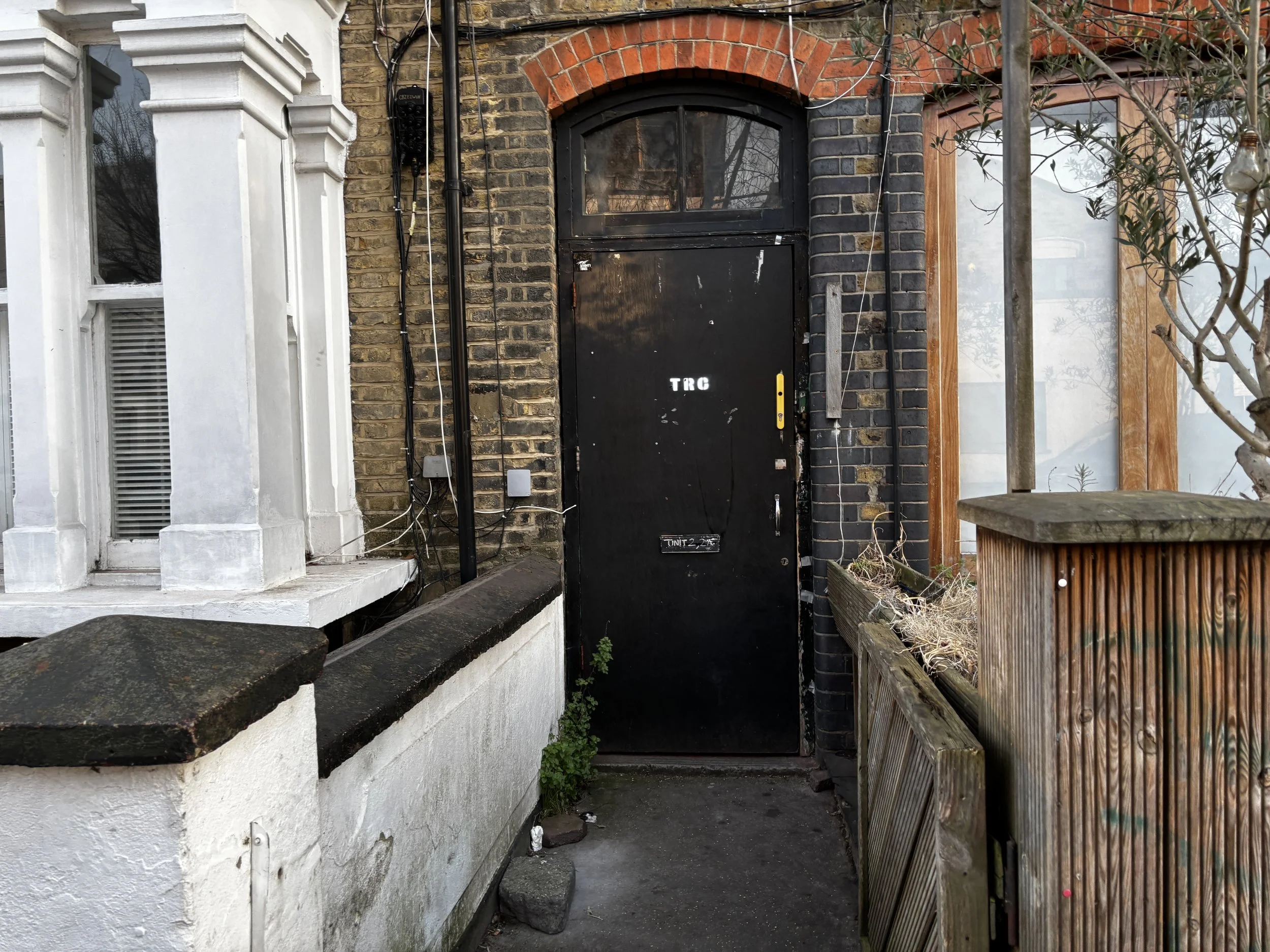 a black door with the letters TRC on it.