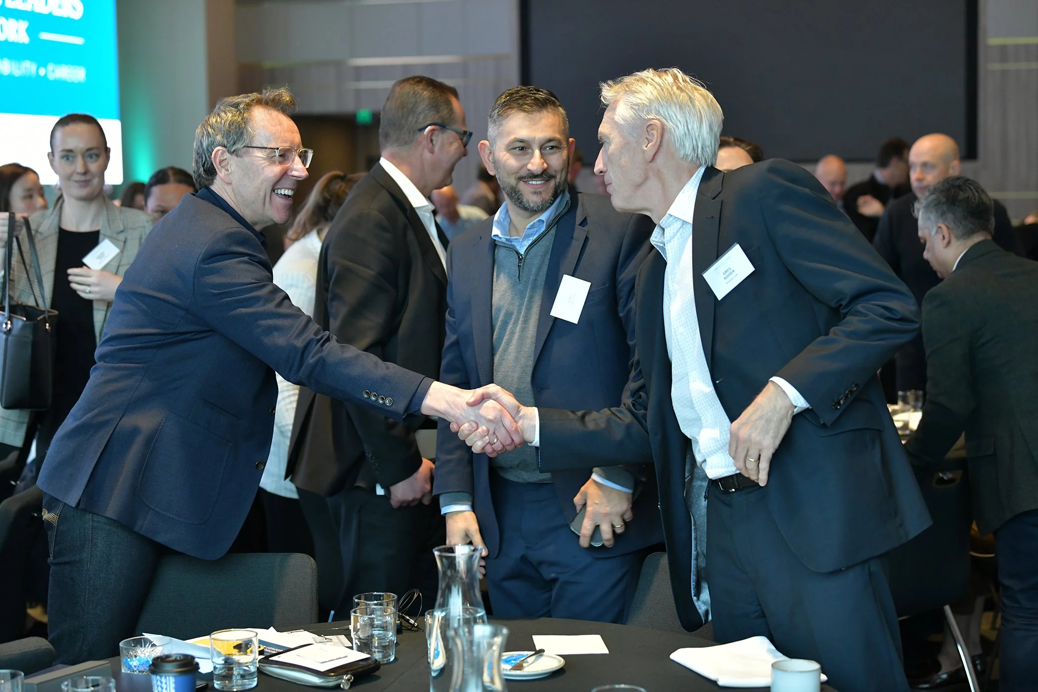 Delegates, shaking hands at sit down, event.jpg