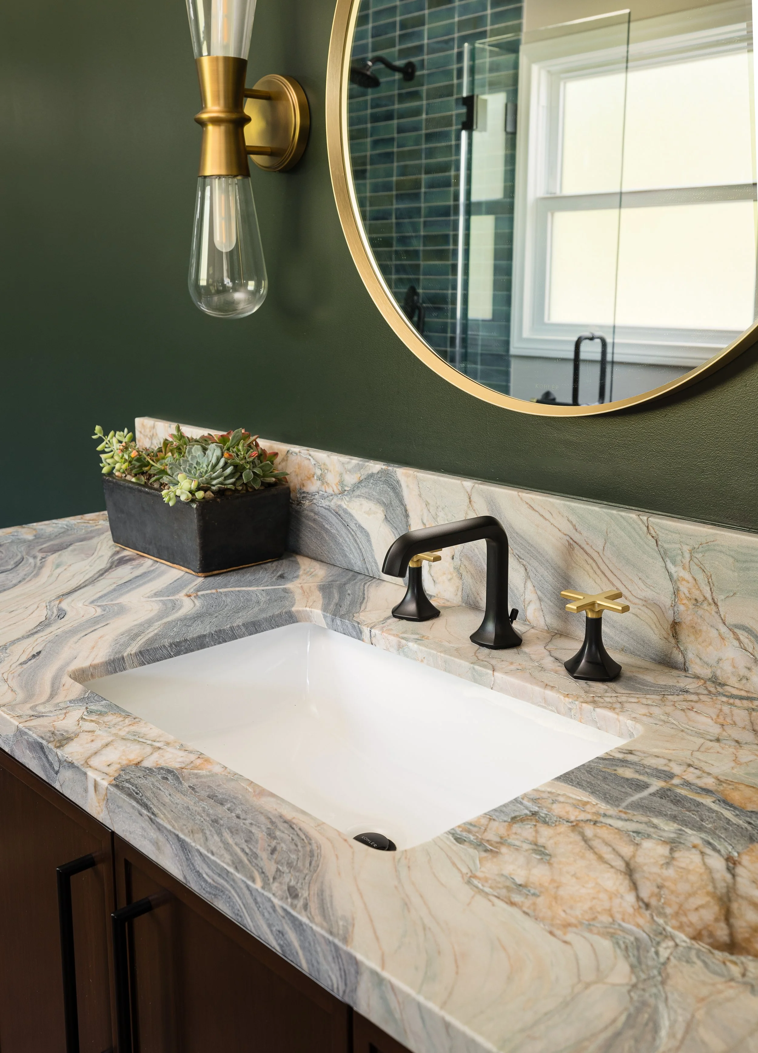 Bathroom vanity with a swirling marble countertop and white undermount sin