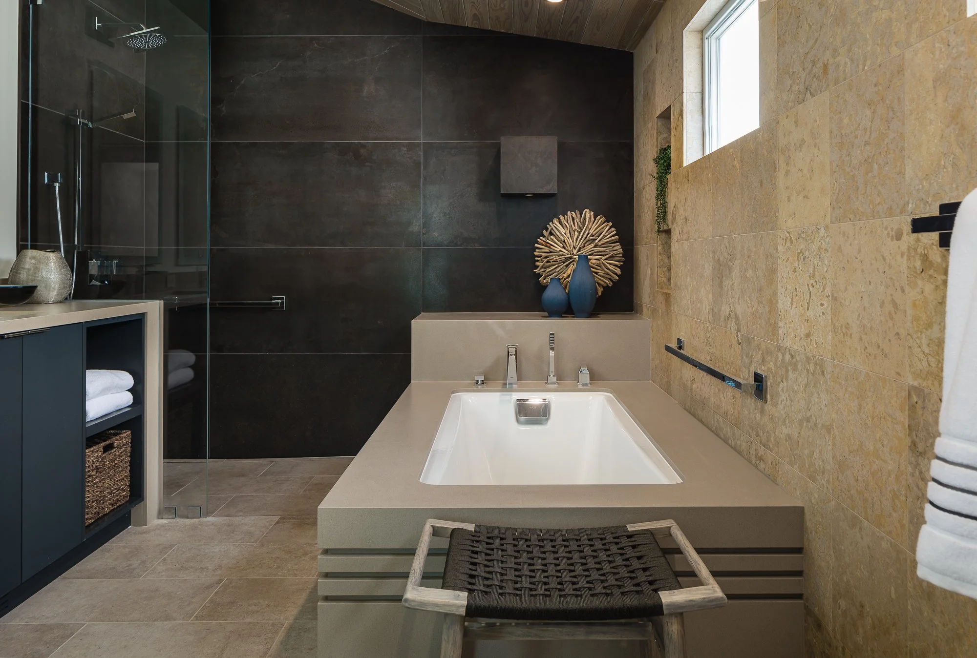 Spa-style primary bathroom with soaking tub and wide tub deck designed for aging-in-place remodeling