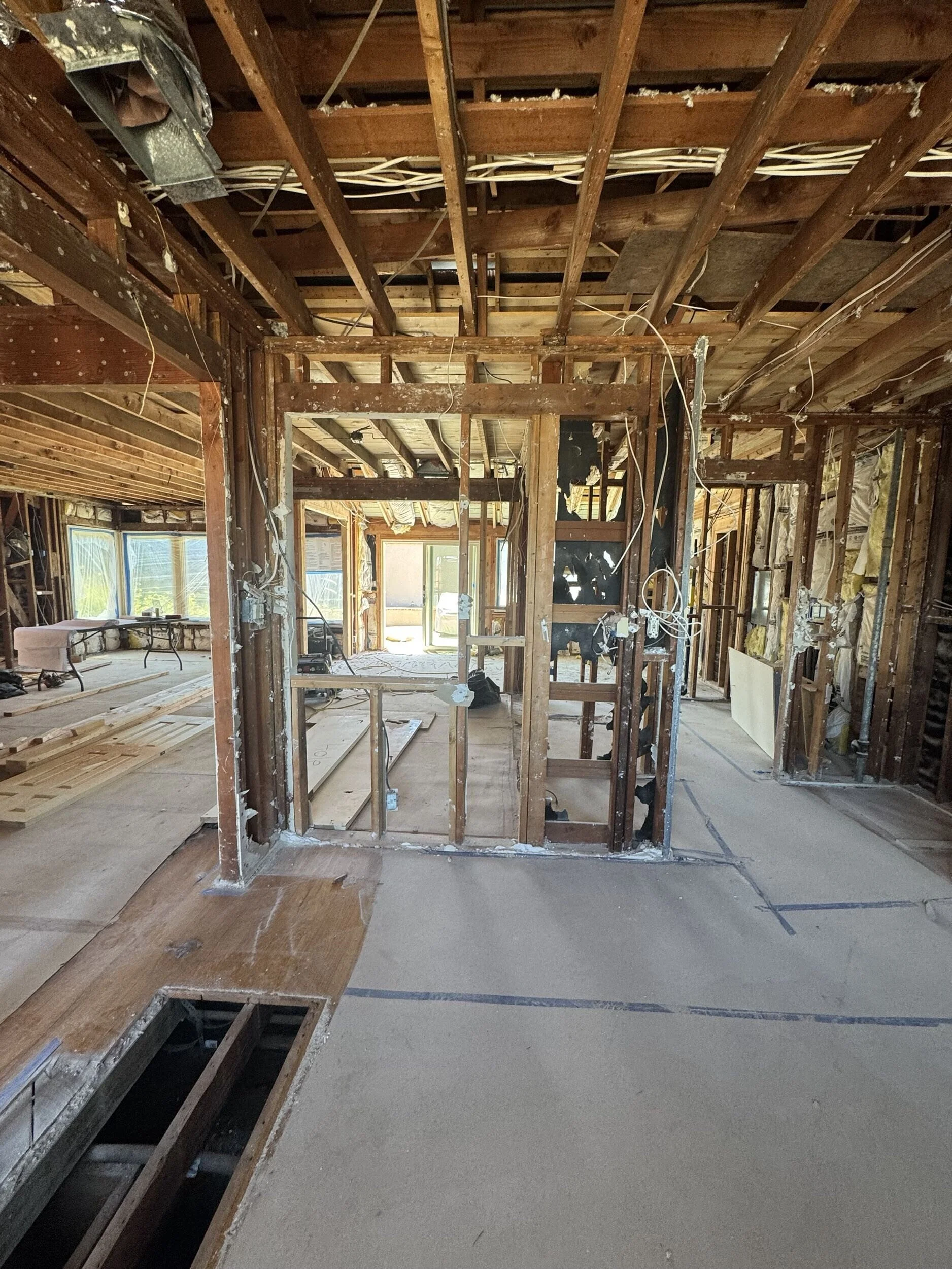 Alternative angle of house interior stripped to wooden beams