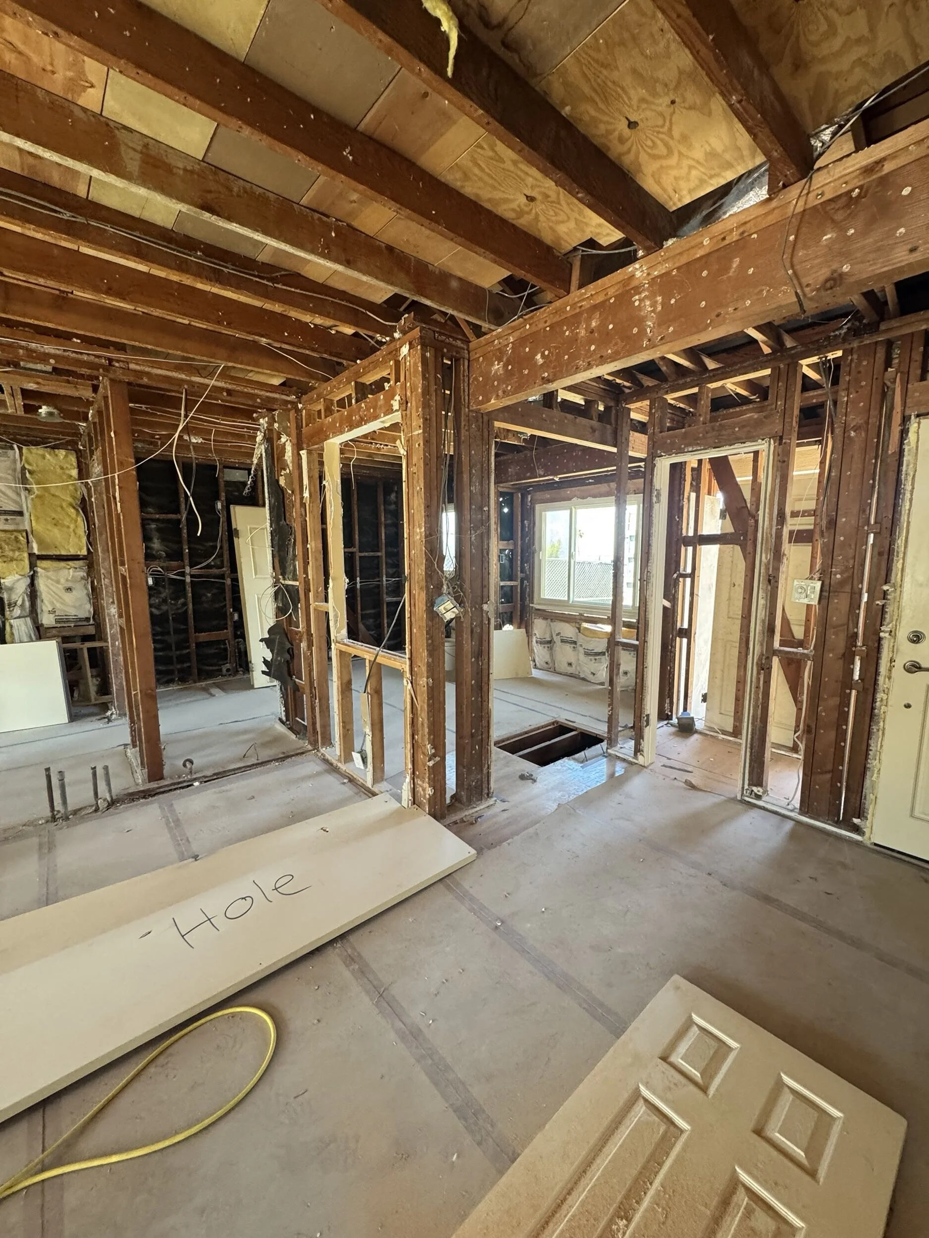 Alternative angle of house interior stripped to wooden beams