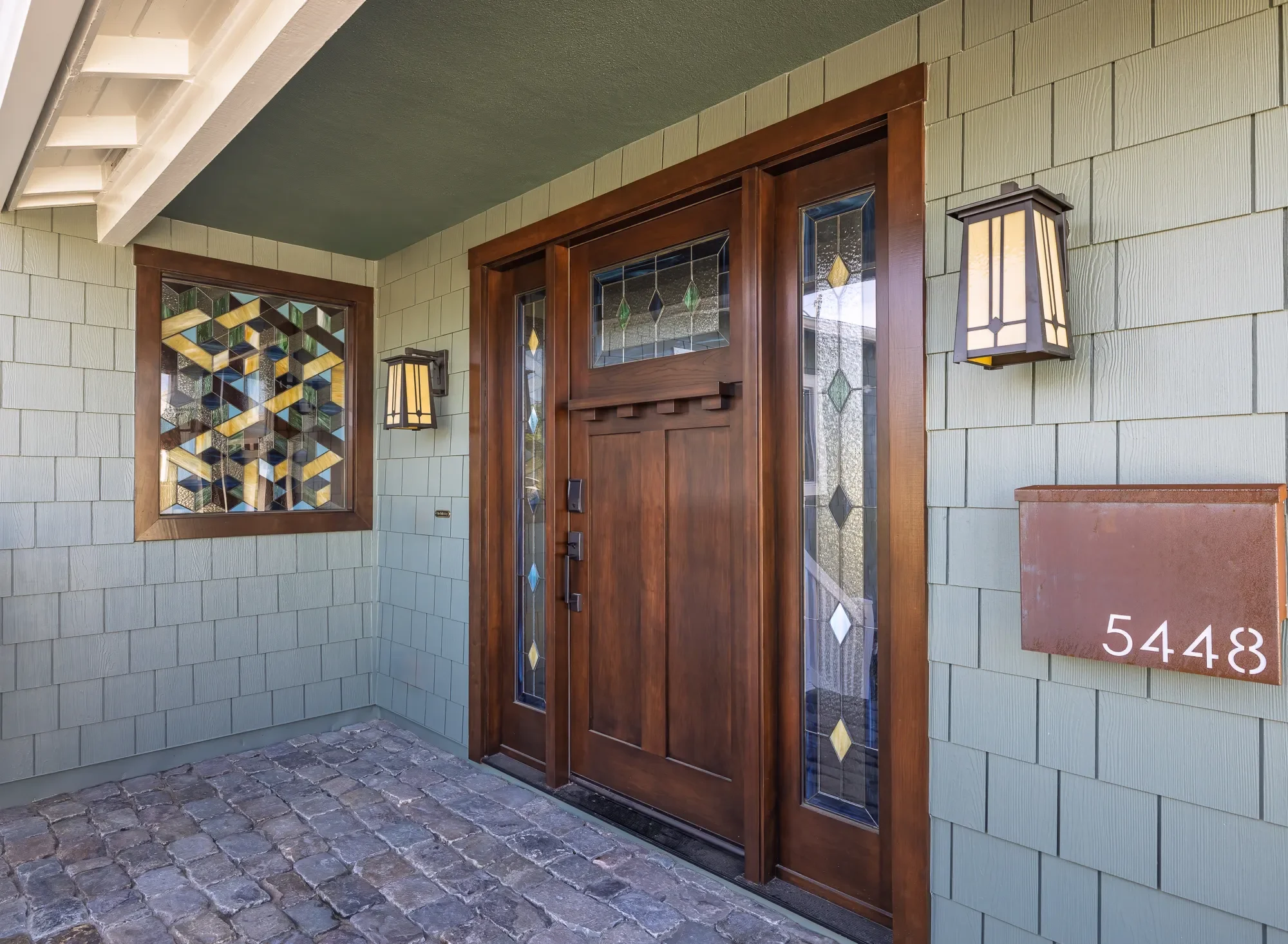 Custom front door with stained glass sidelights and matching window