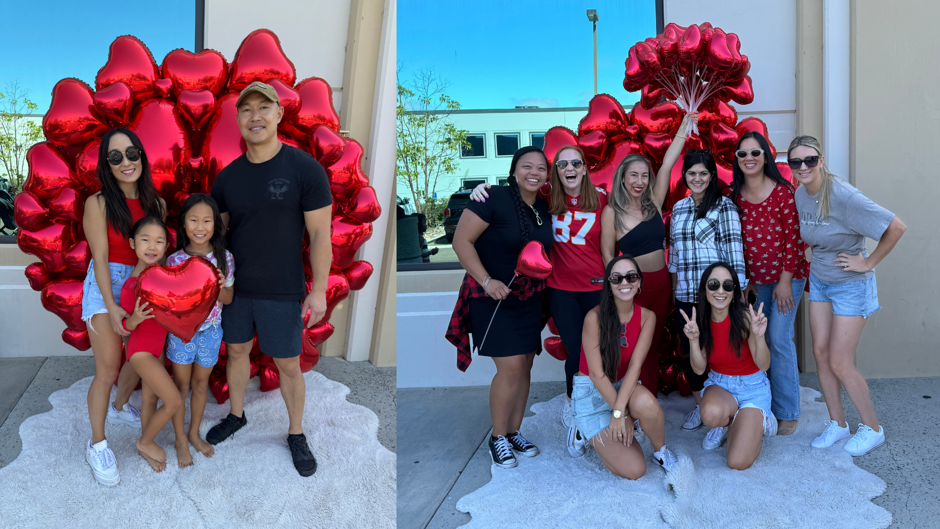 Two groups of women and children smiling in front of red heart-shaped balloons, with one group holding a bouquet of balloons. They are outside a building with a reflective window and a chain-link fence visible in the background.