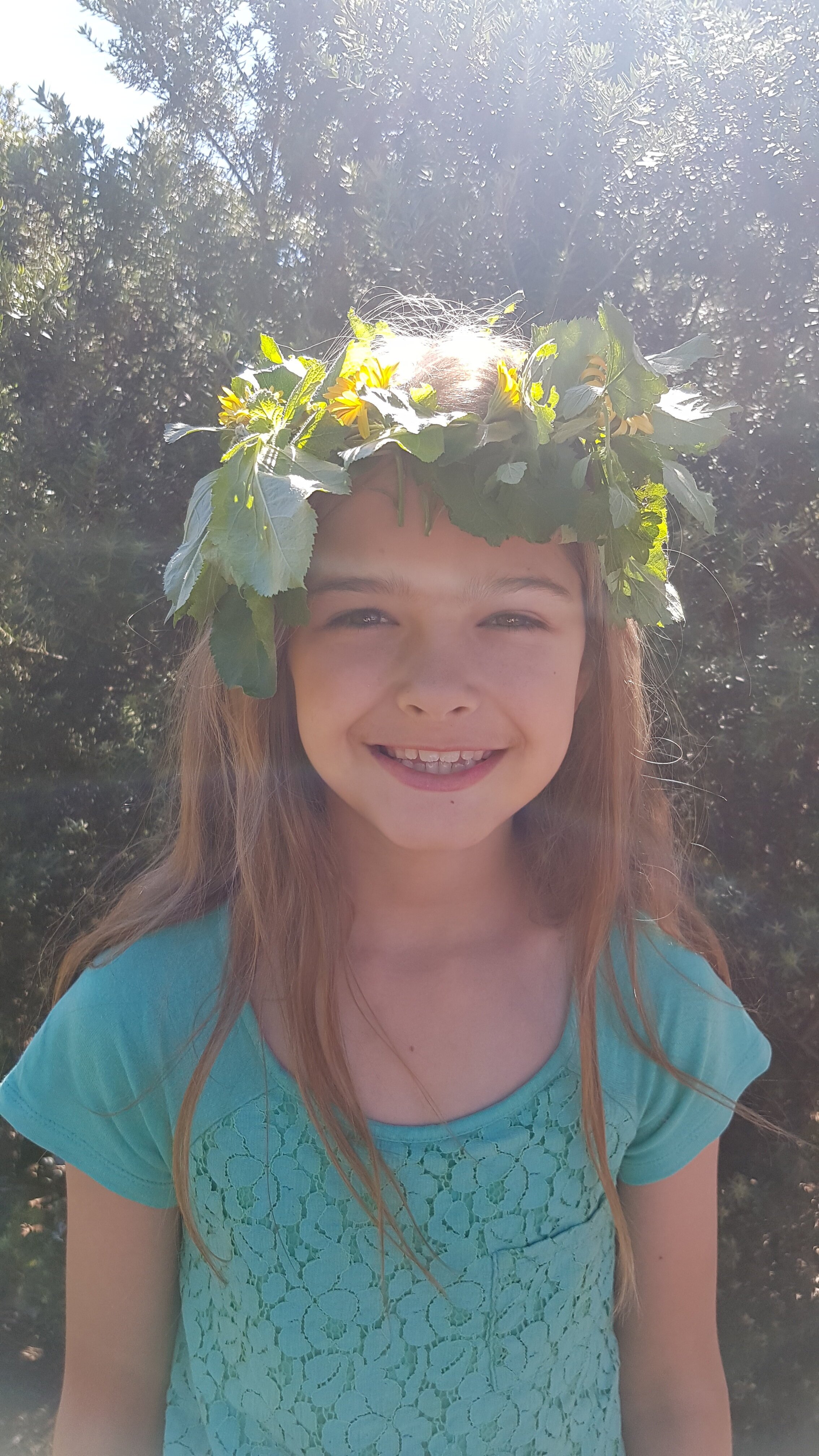photo 4 - i like playing in the garden, this is a crown I made.jpg
