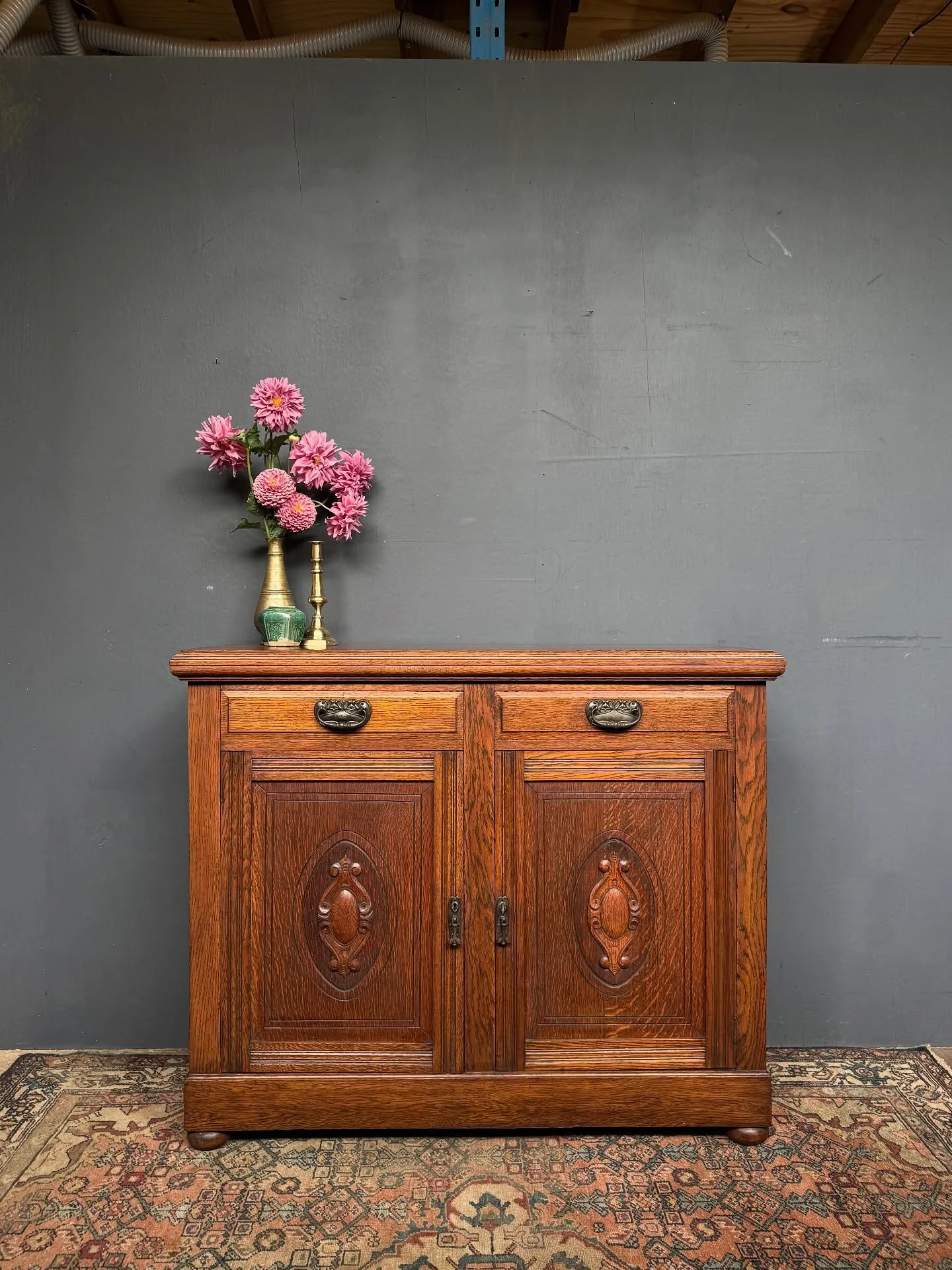 We like this Edwardian Oak sideboard, circa 1910.  Wonderfully solid with two drawers and cupboards below. Beautiful Art Nouveau handles. 
It measures 1220mm wide x 475mm deep x 1005mm high. $890