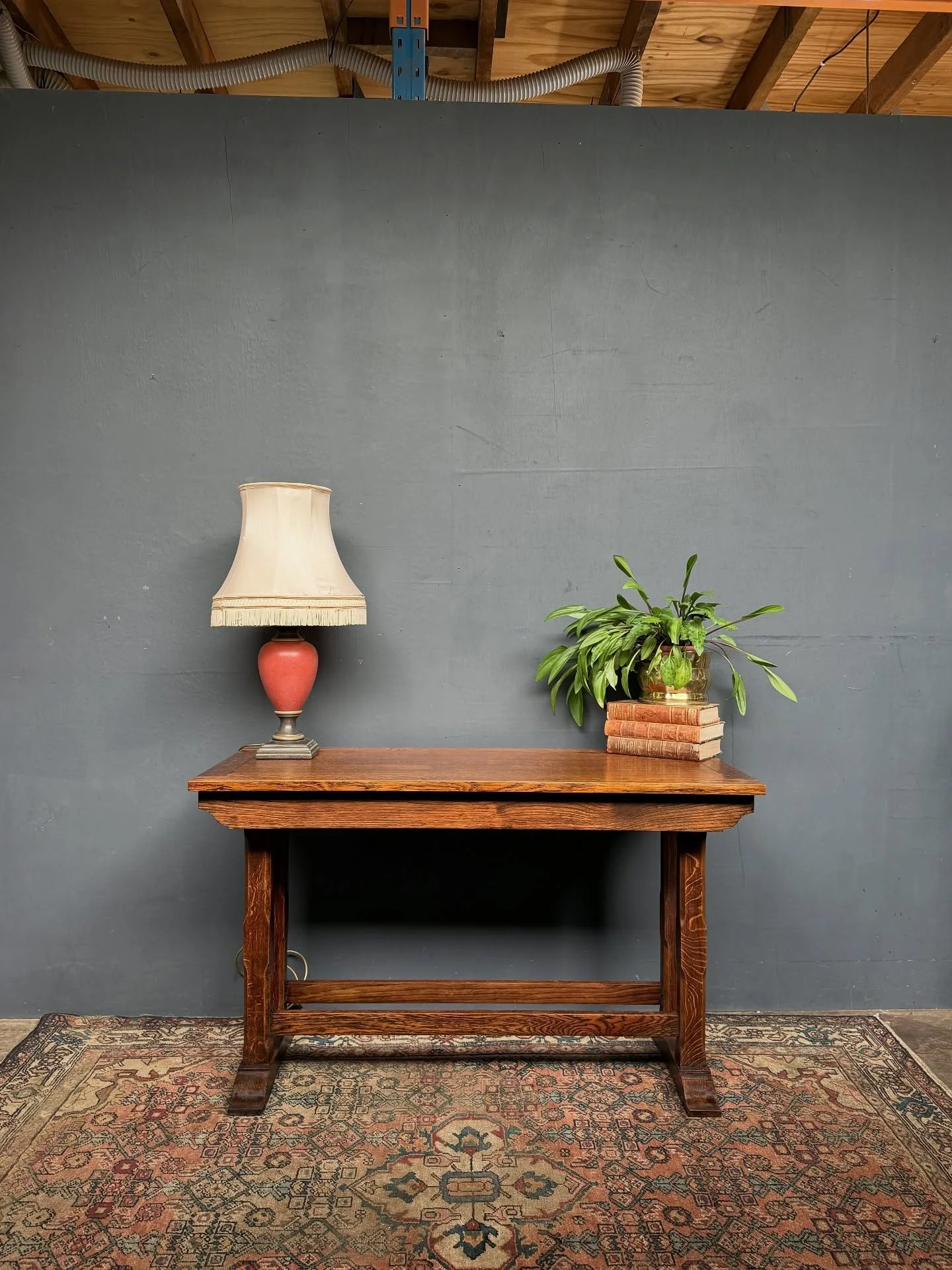 Early 20th C Oak console table, Arts and Crafts design, nice patina and simple form with chamfered legs and double stretcher.  It measures 1215mm wide x 530mm deep x 725mm high $680