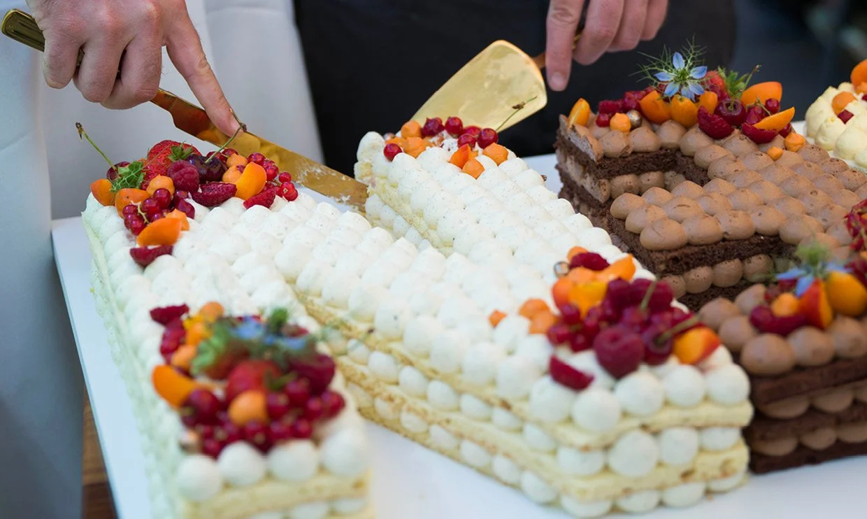 Cutting a wedding or celebration cake during a special occasion at ANIMO by Aigner in Salzburg