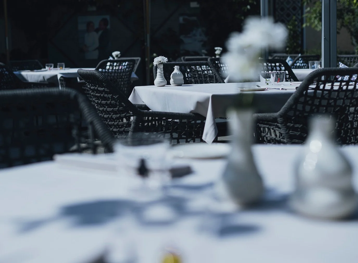 Set table in the sunny garden of ANIMO by Aigner in Salzburg