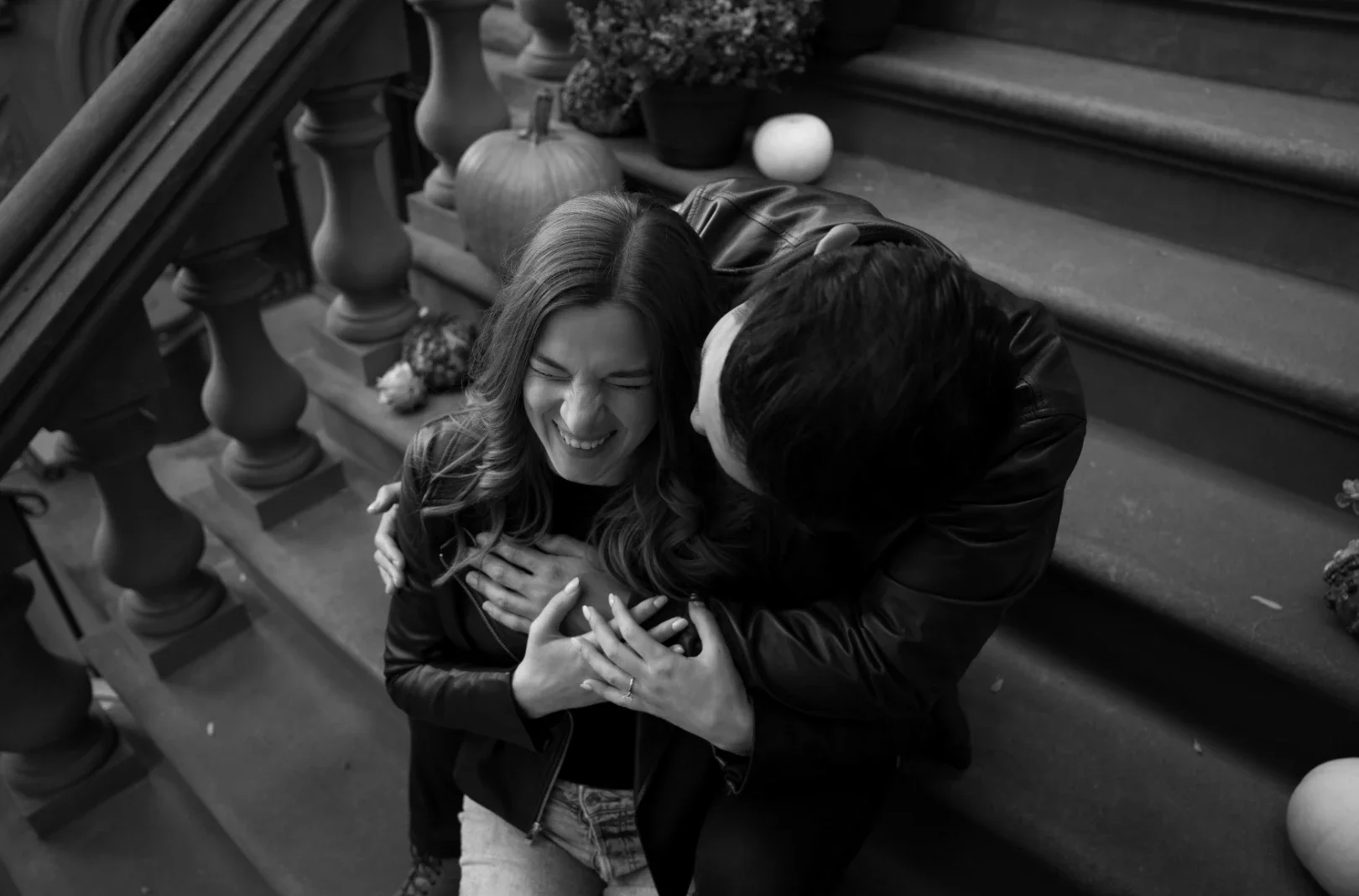 couple cuddling on stairs in new york city