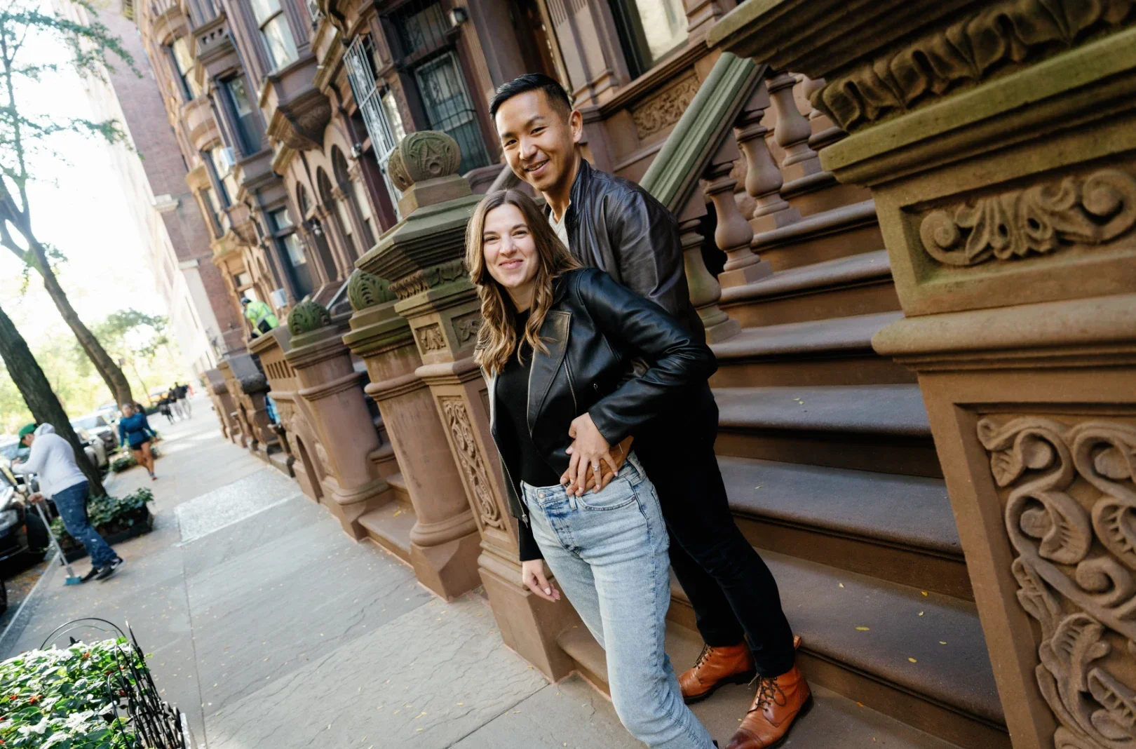 couple embracing in front of stairs in New York City