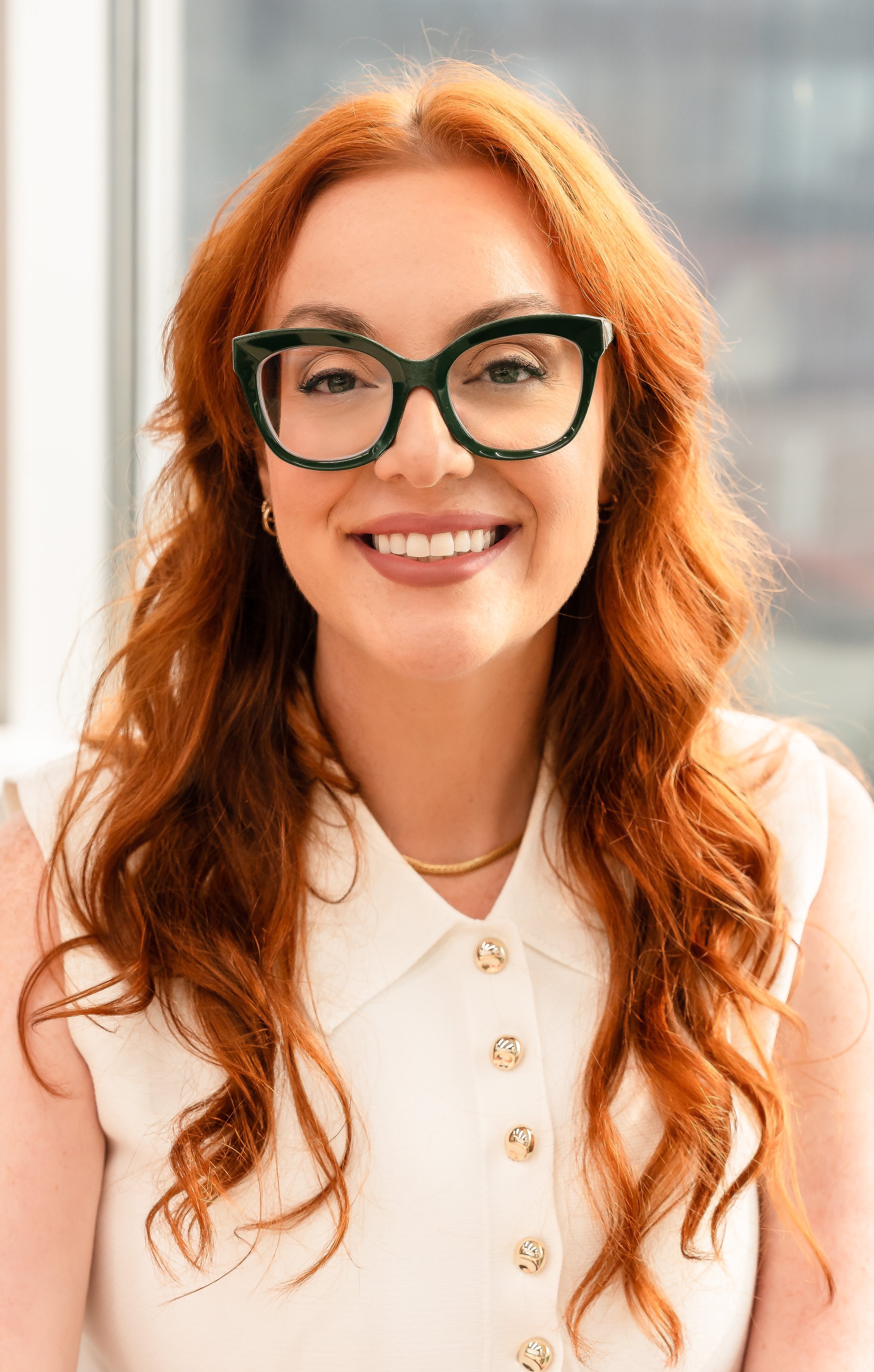 Smiling redhead in office linkedin photo