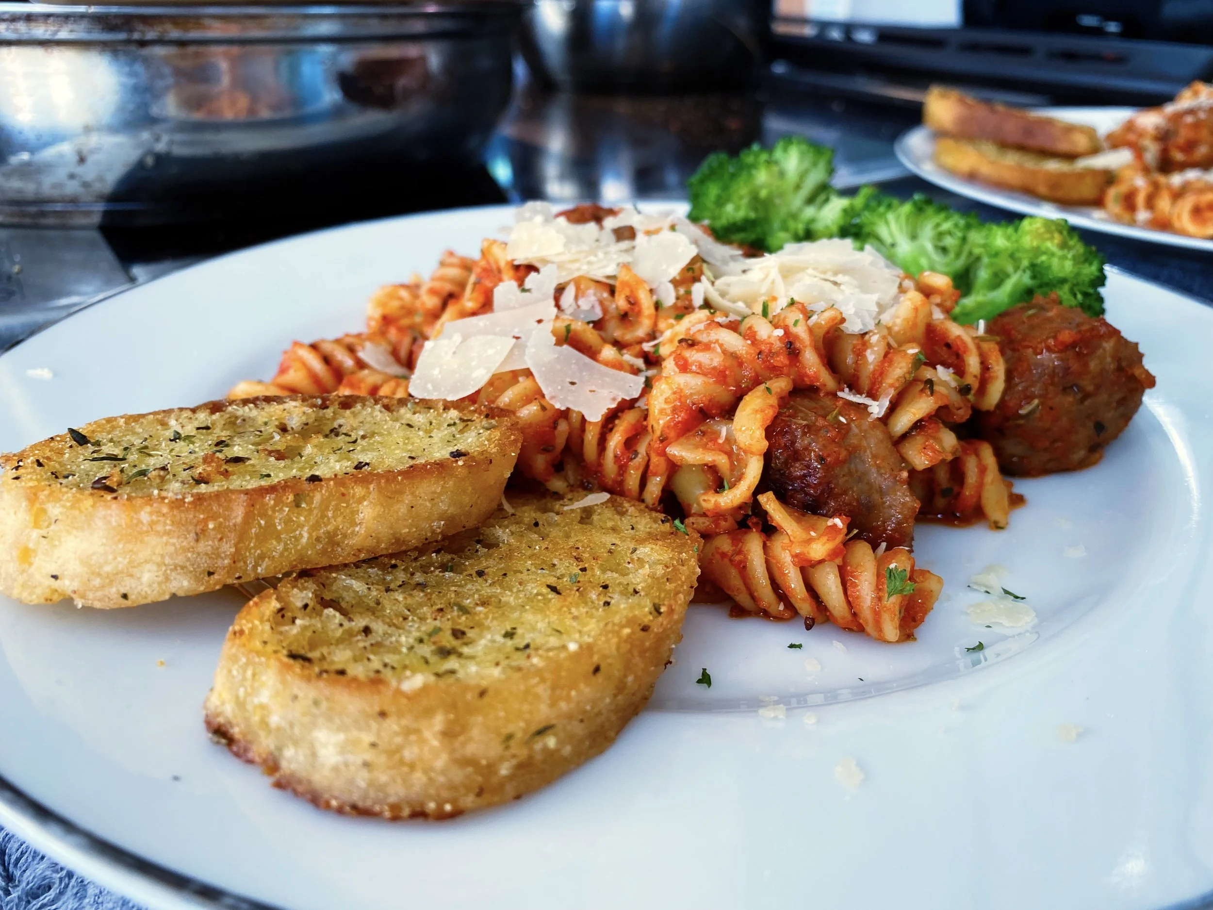 Italian Rotini Pasta with Sausages with a side of Broccoli and Toasted Italian Garlic Bread