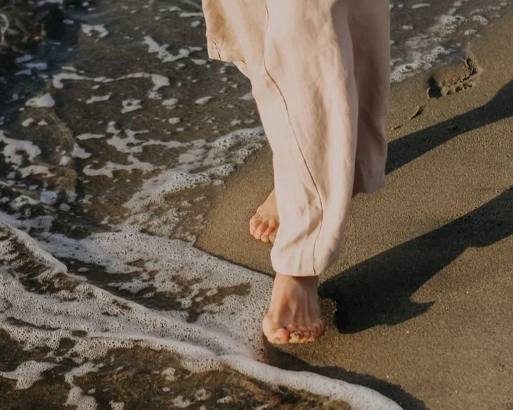 high achiever woman walking in the beach for a reset
