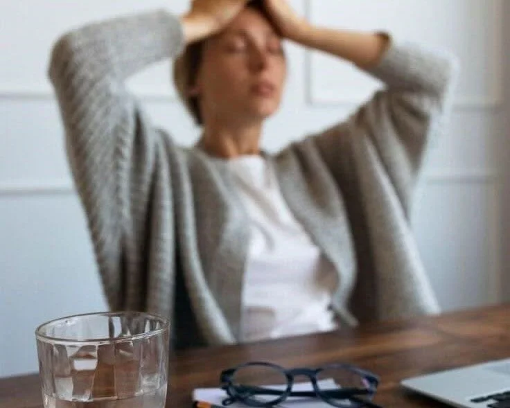 "High-achieving woman in her 40s experiencing chronic stress and burnout signs. Life coach for women in midlife."
