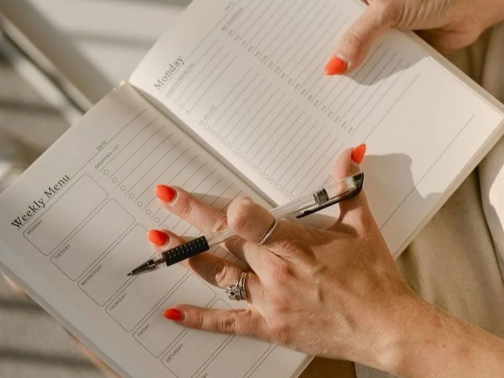 busy woman with planner thoughtful