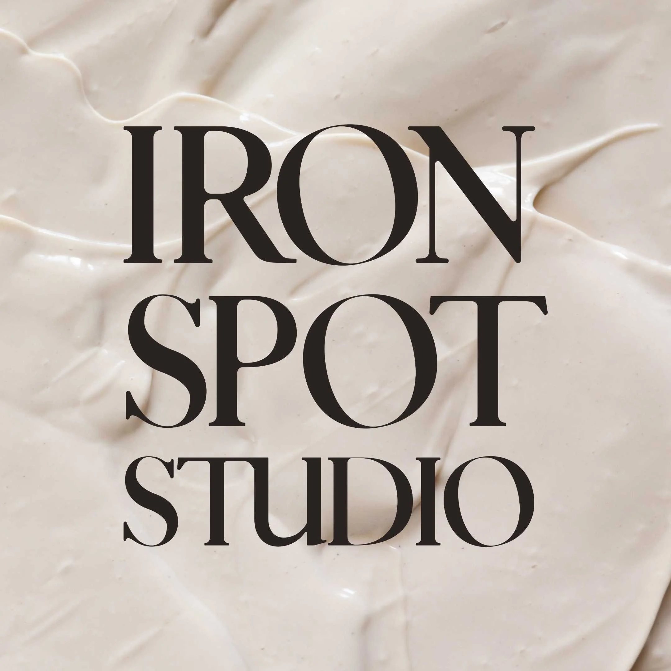 Iron Spot Studio black logo over an image of wet clay slip designed by VVITCH Digital Agency VA