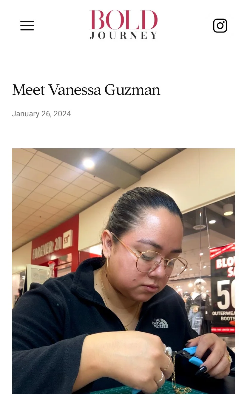 Person concentrating on crafting jewelry in a retail environment, using pliers and a chain.