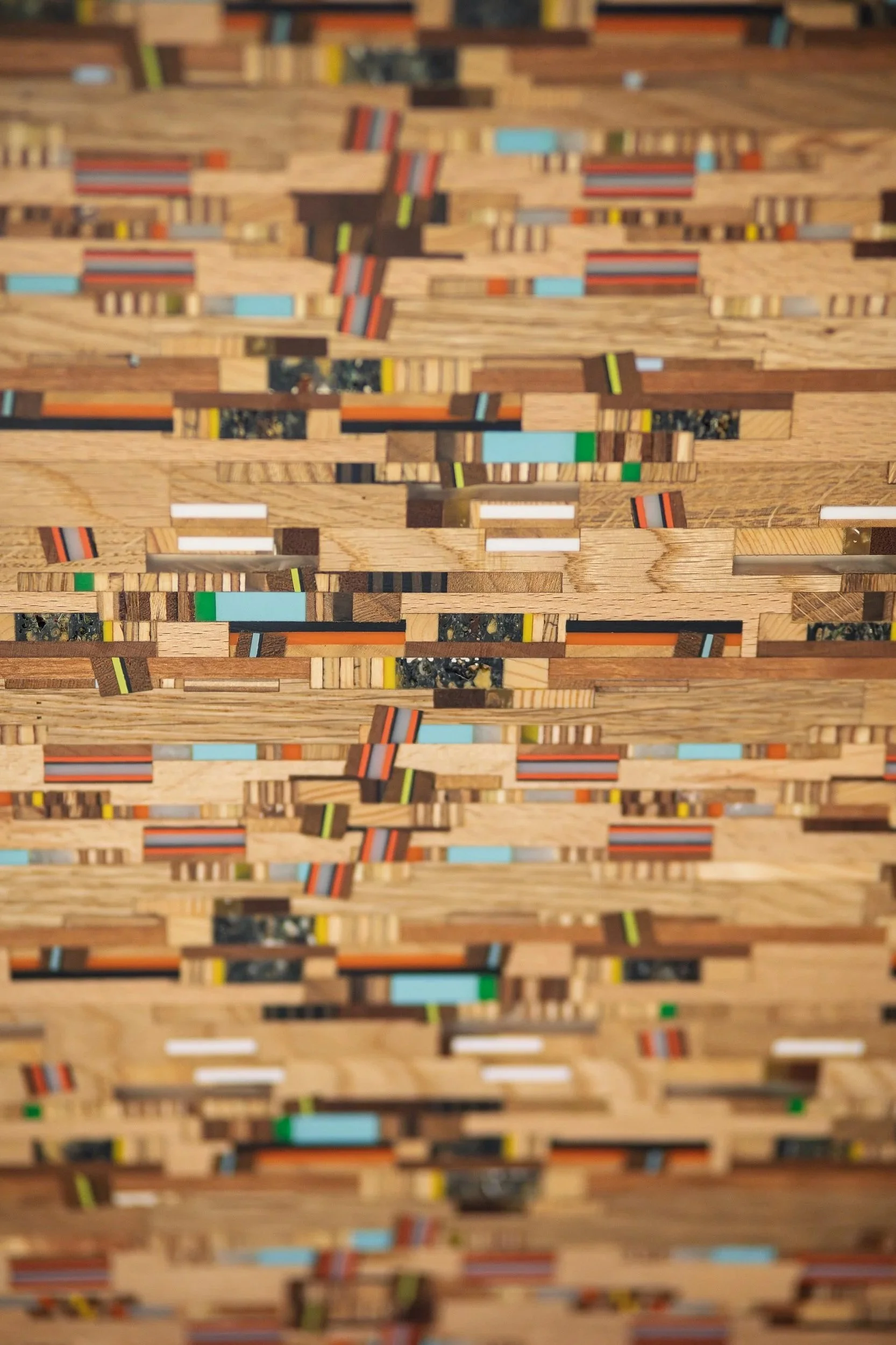 Close-up view of a wooden mosaic pattern with colorful inlays.