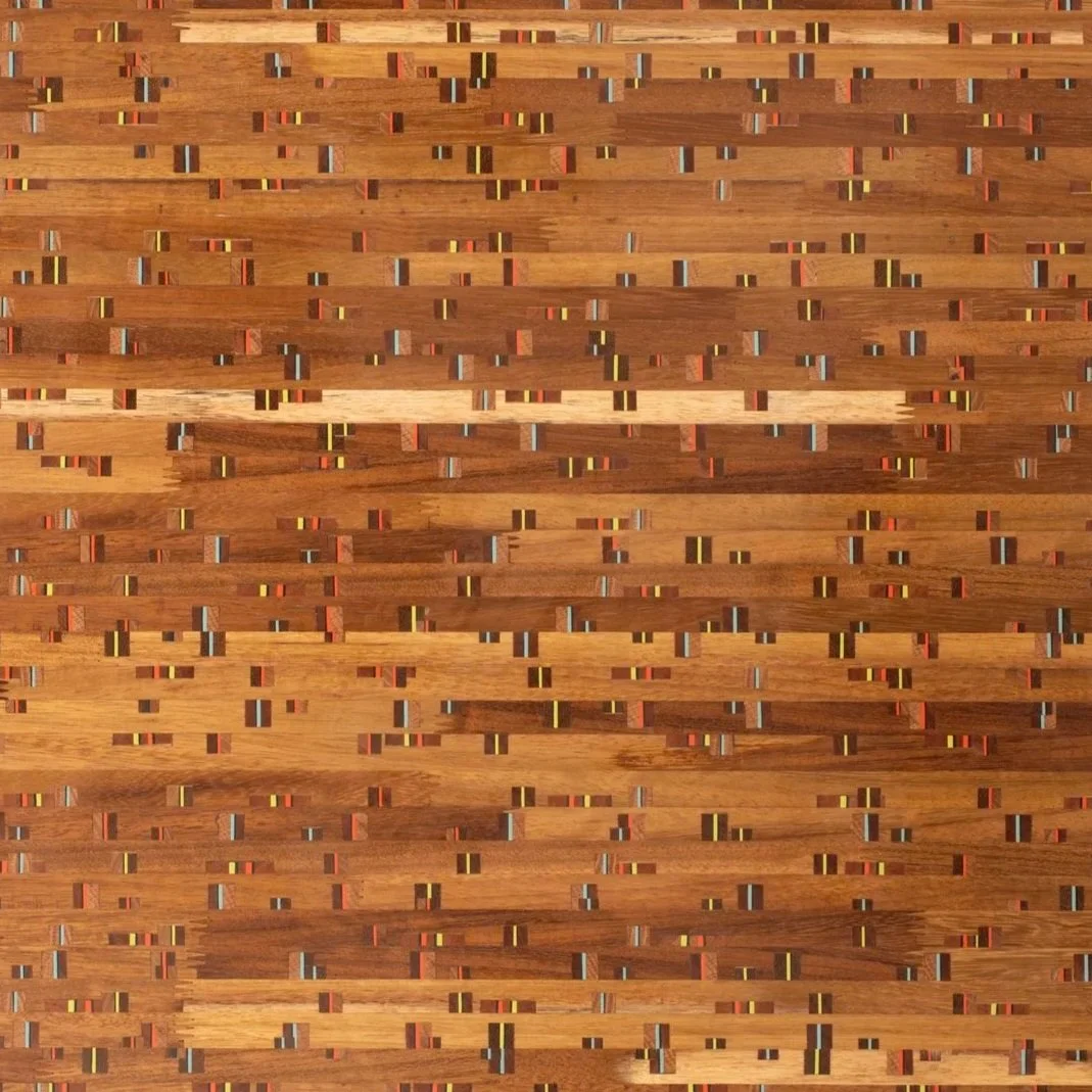 Close-up of a wooden surface with small, multicolored rectangular accents creating a textured, pattern design.