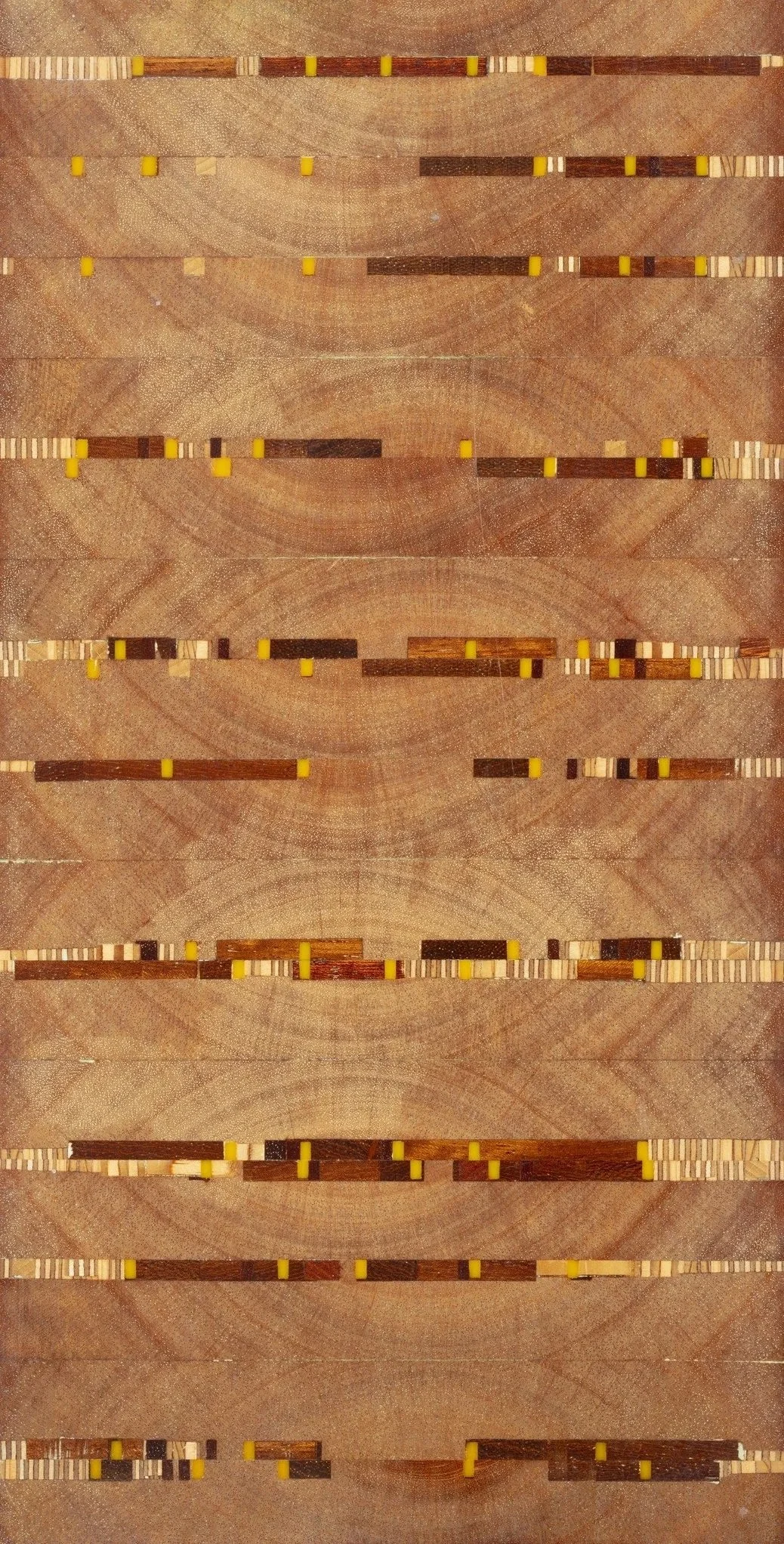 Close-up of wooden dominoes arranged in multiple horizontal lines on a wooden surface.