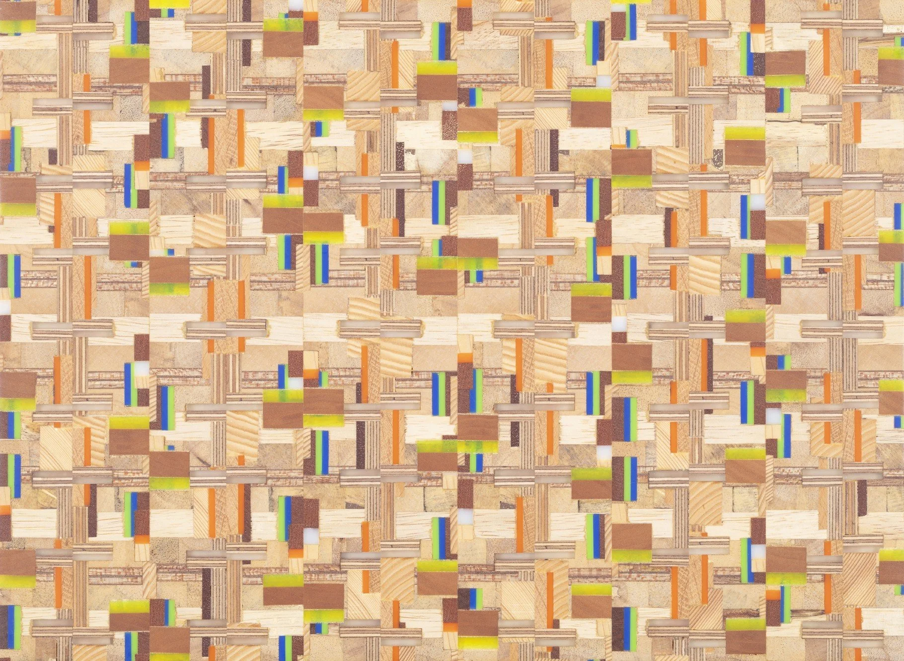 A close-up image of a woven pattern made from various small rectangular and square pieces of wood with different colors and textures, creating a complex, visual mosaic.