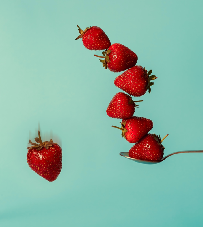 Strawberries balancing on spoon